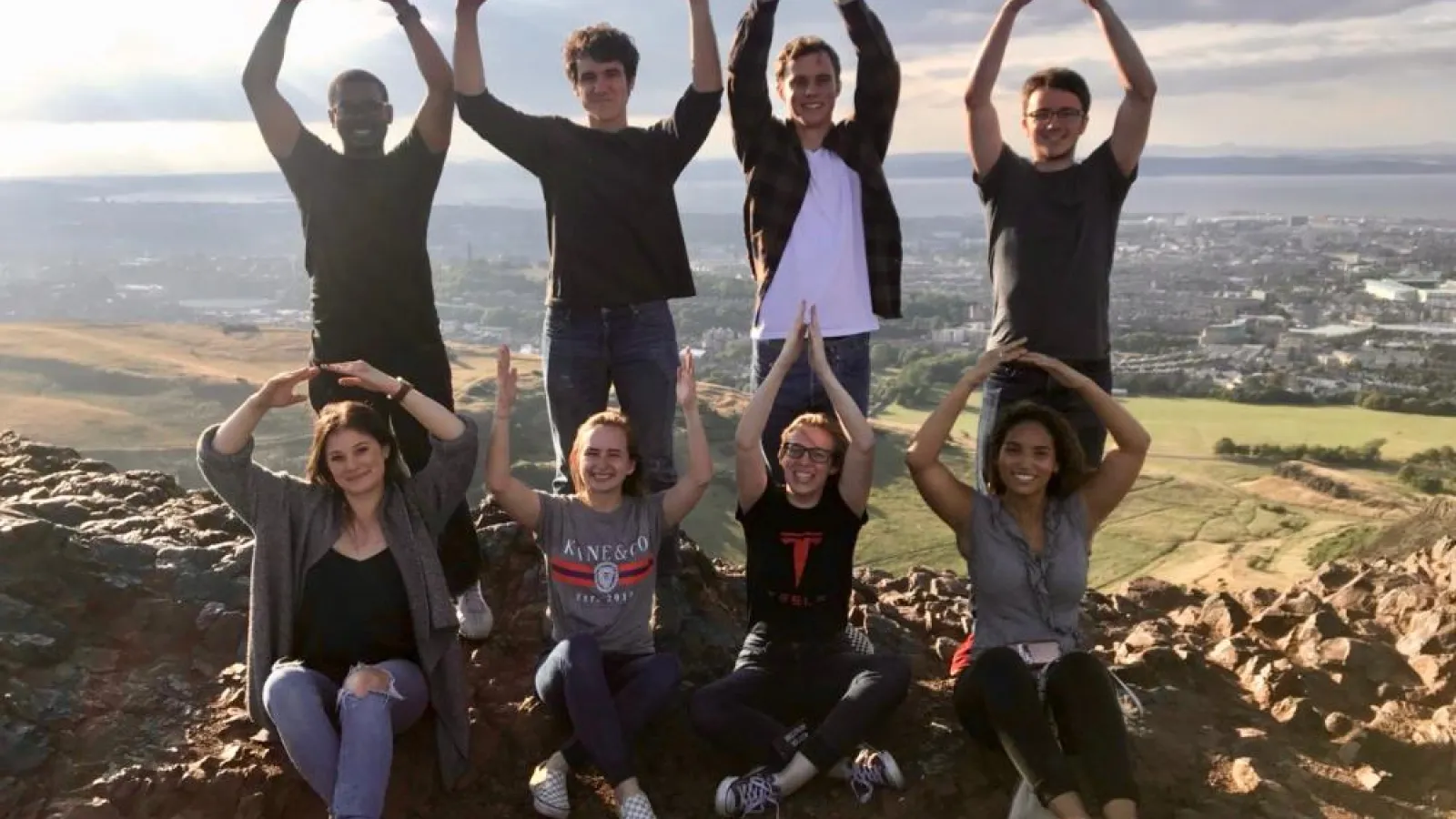 Students spelling out Ohio with their arms. 