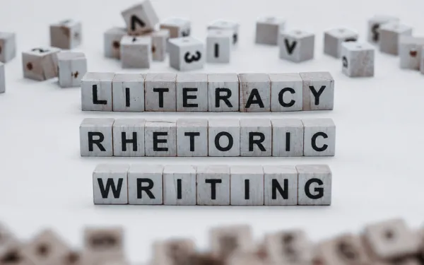 the words writing, rhetoric, literacy as wooden blocks