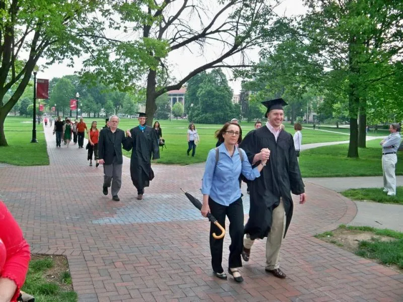 Brenda Brueggemann walking with graduates