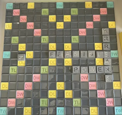 3d printed scrabble board with tiles that read "arrears, feasible, power"